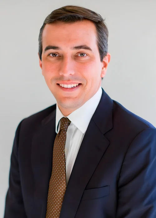 Formal business headshot of Drew McNutt, co-counsel attorney with Trident Law HQ, shown in front of a solid backdrop.
