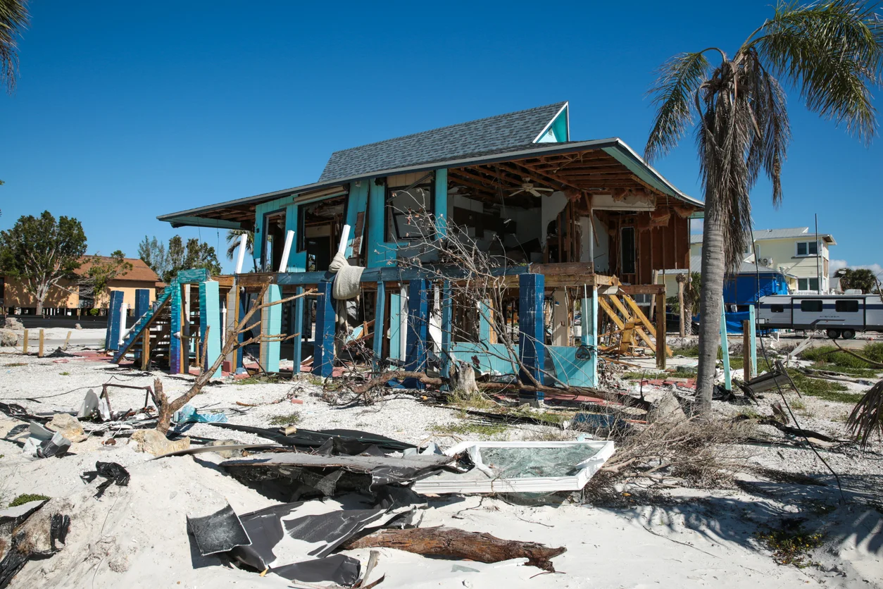 A photo of a house that has been damaged a bit by a hurricane illustrating catastrophic coastal or inland destruction from hurricane damage claims managed by Trident Law HQ