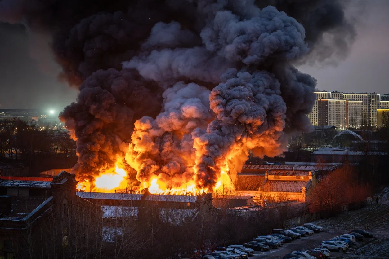 Building on fire illustrating property losses and fire damage insurance claims managed by Trident Law HQ
