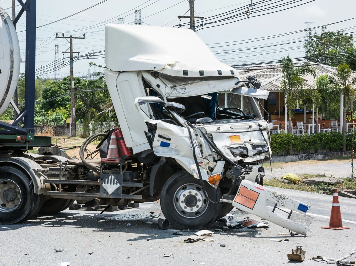 Trident Law HQ represents victims of commercial vehicle crashes, depicted by an image of a white 18-wheeler that has been totaled on the front end in an accident