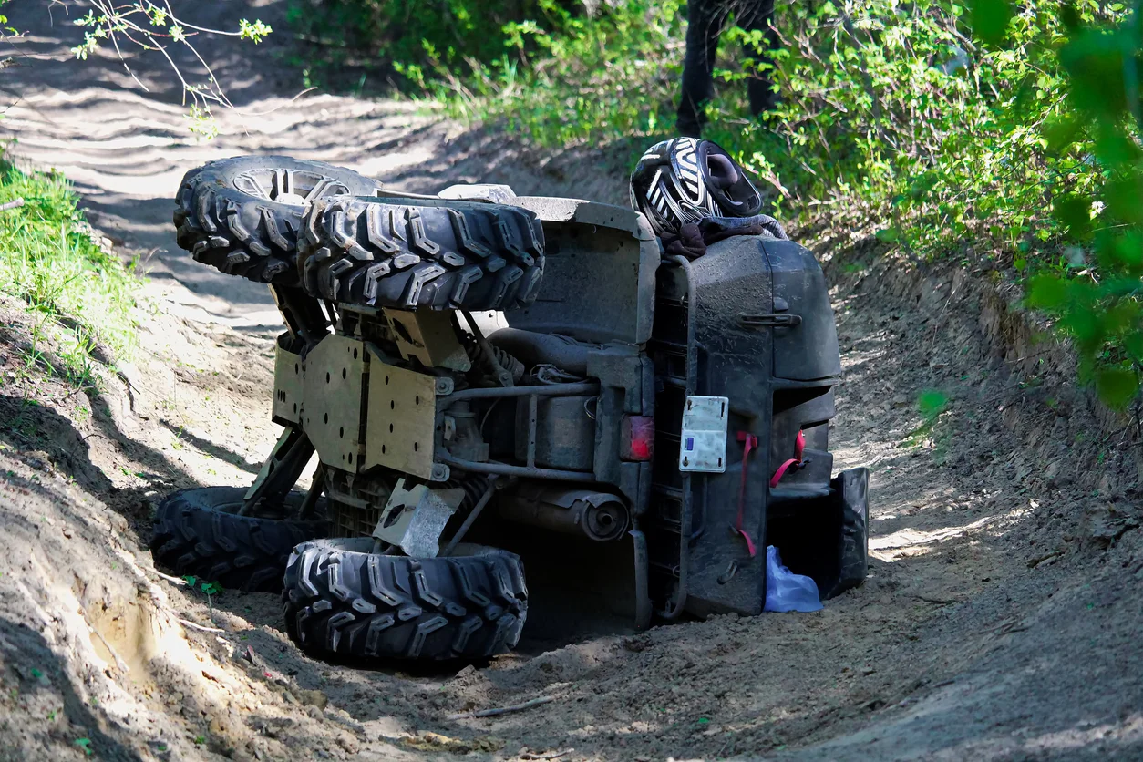 A photo of an ATV that has been flipped onto its side showing overturned vehicle to represent rollover accident claims managed by Trident Law HQ