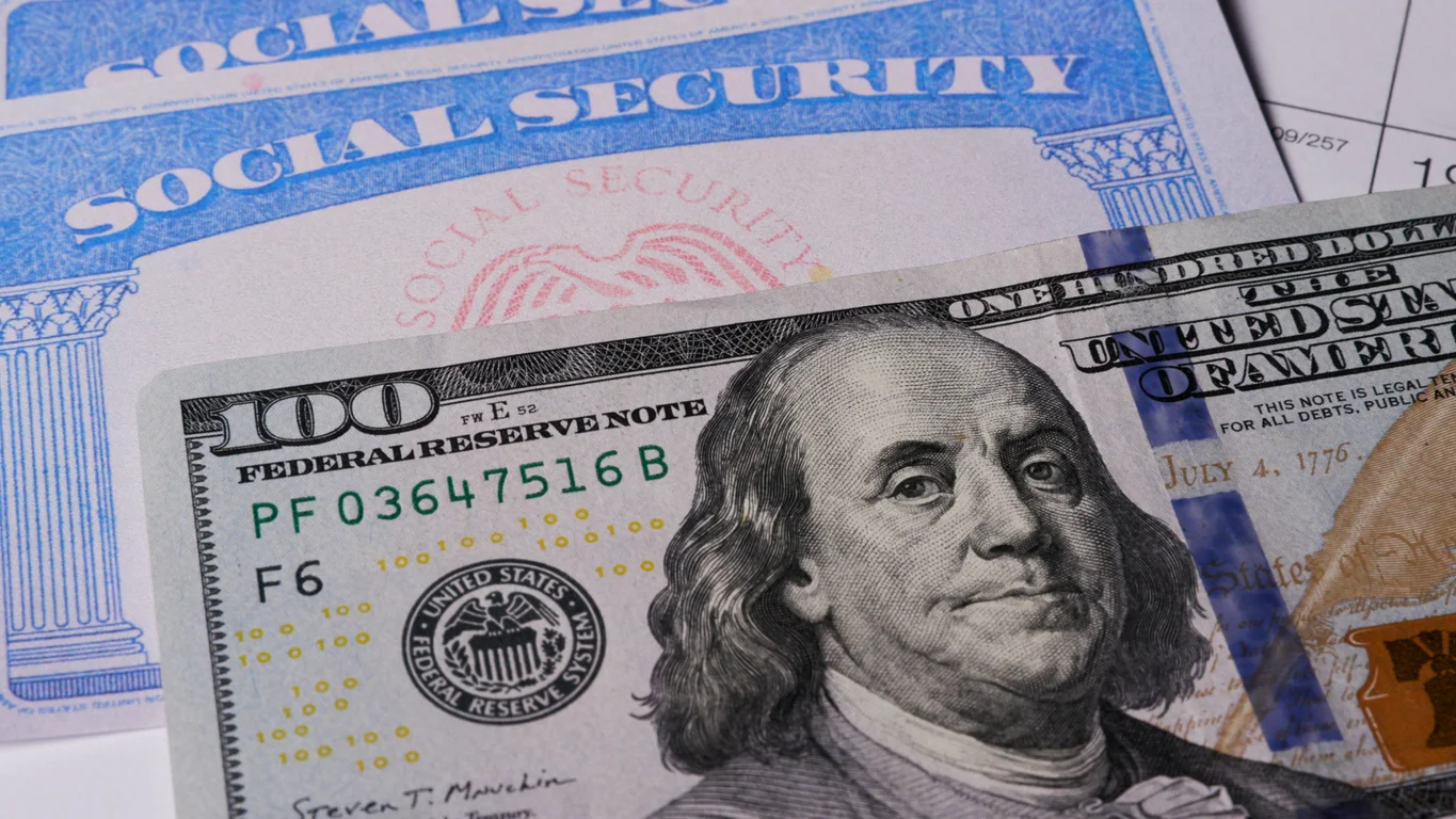A close up image of a twenty dollar bill on top of a social security card symbolizing social security disability challenges addressed by Trident Law HQ attorneys